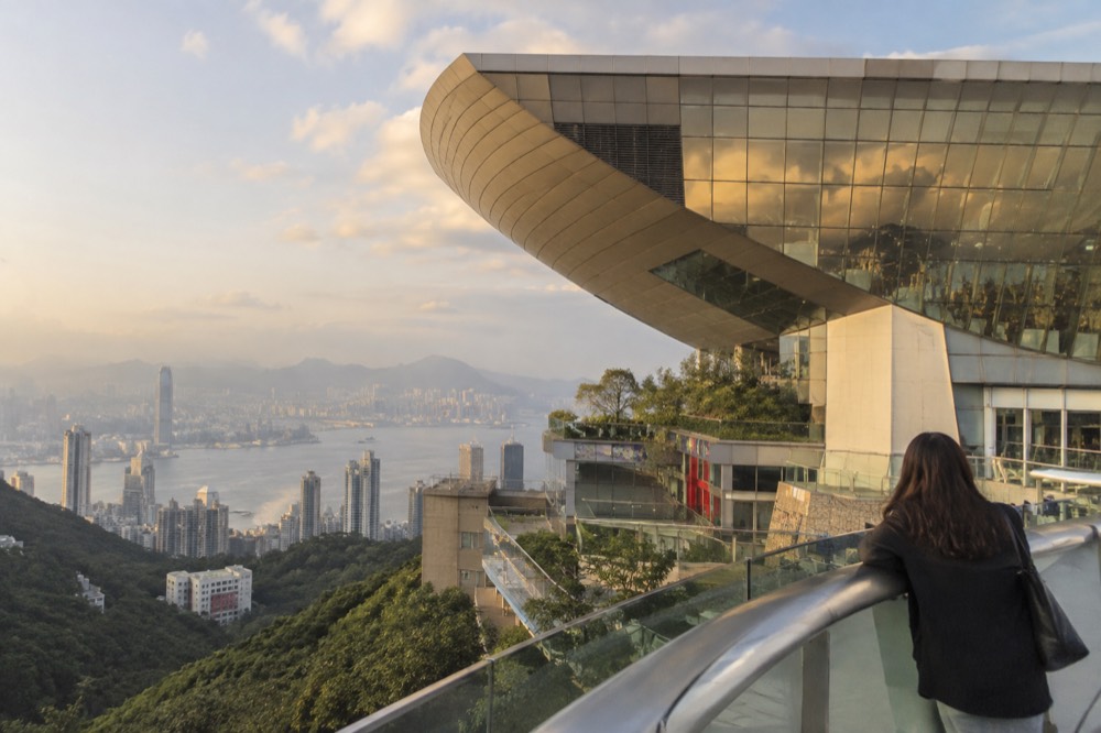 The wok-shaped Peak Tower building seen from the surrounding walkway