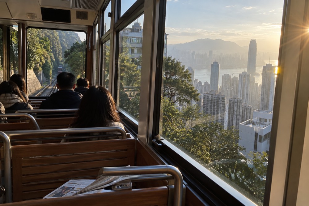 The interior of a Peak Tram carriage with wide panoramic windows and rows of seats