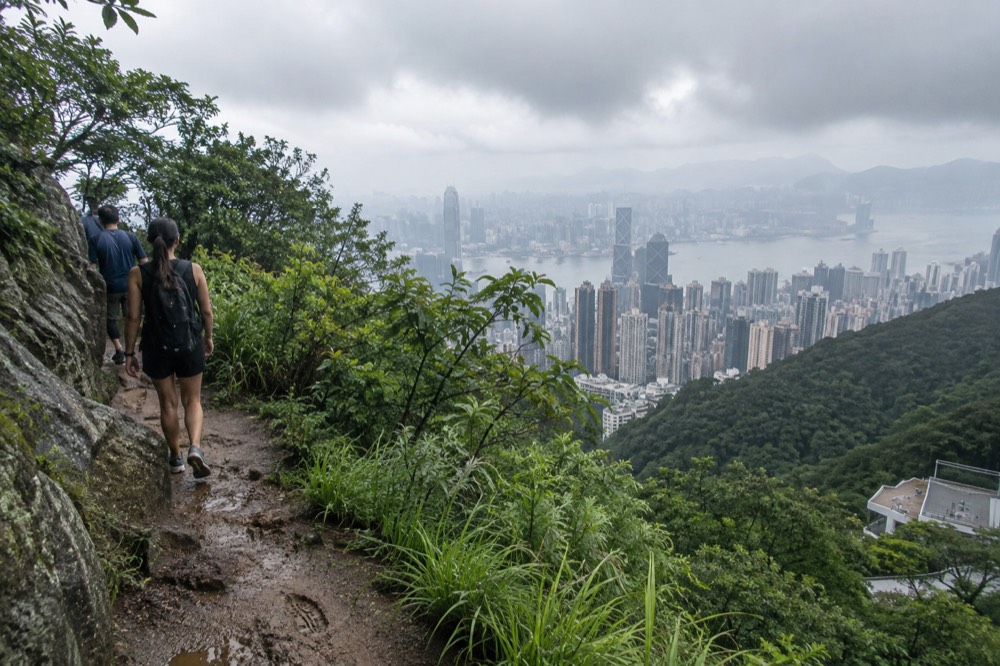 Green mountain slopes under cloud with distant territory hills on the horizon