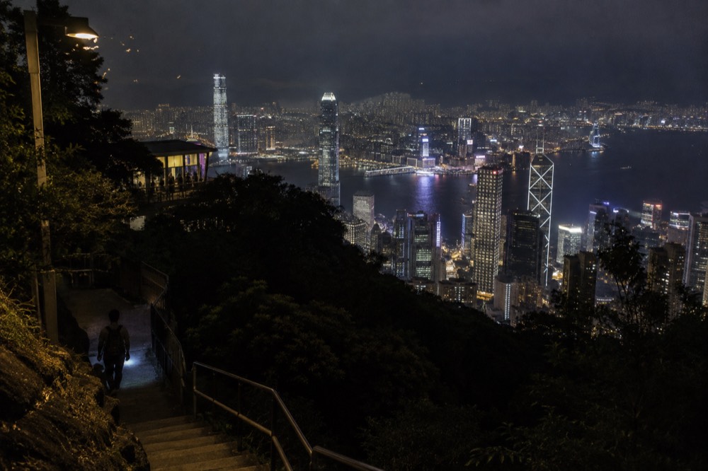 Hong Kong skyline and harbour lights seen from high on the Peak hillside at night