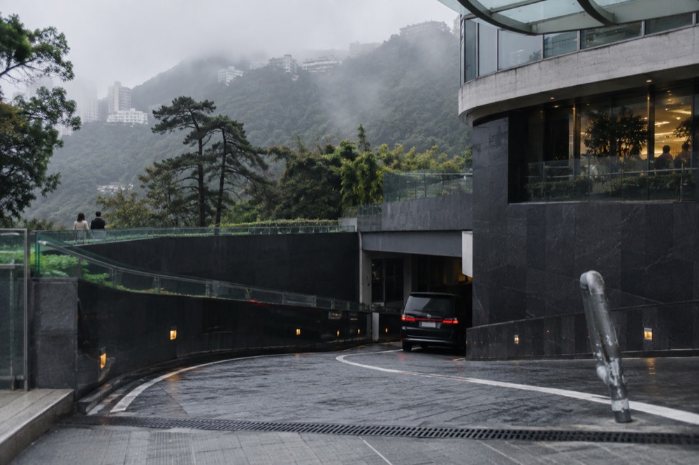 A car park entrance beside a shopping mall building on the Peak