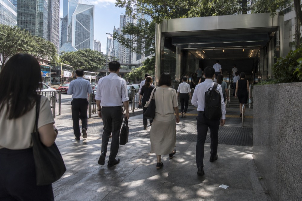 Entrance to Central MTR station in Hong Kong with pedestrians on the street above