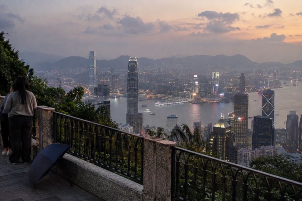 View over Victoria Harbour from a high vantage point on Hong Kong Island at dusk