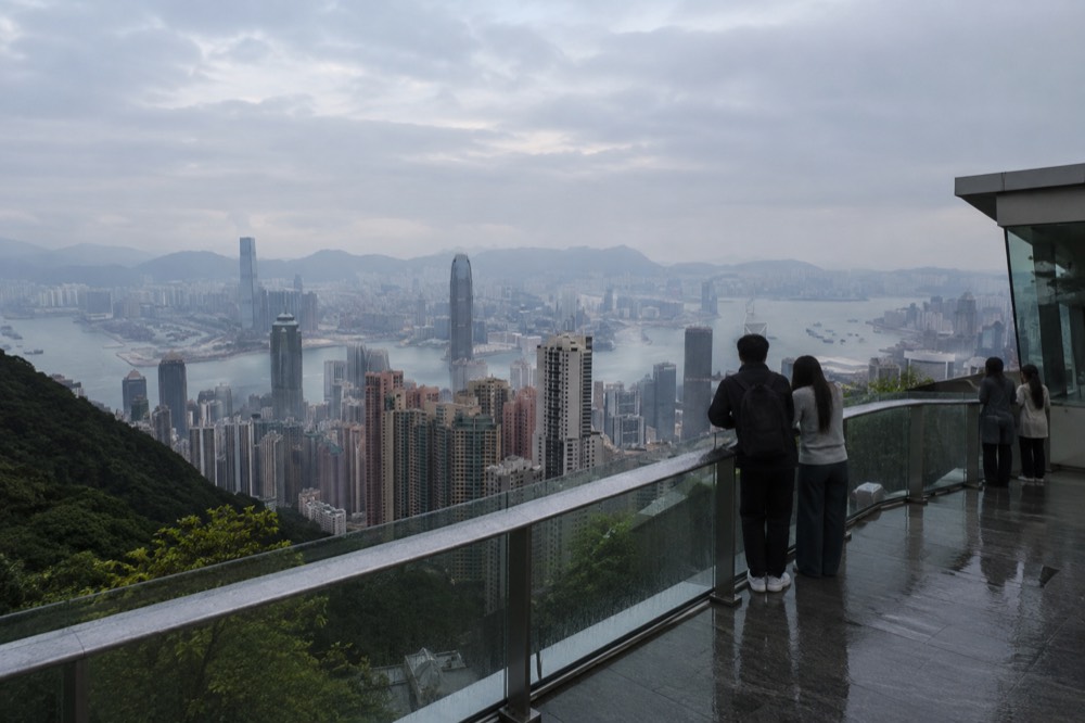 Kowloon peninsula and harbourfront skyline across Victoria Harbour seen from a high viewpoint