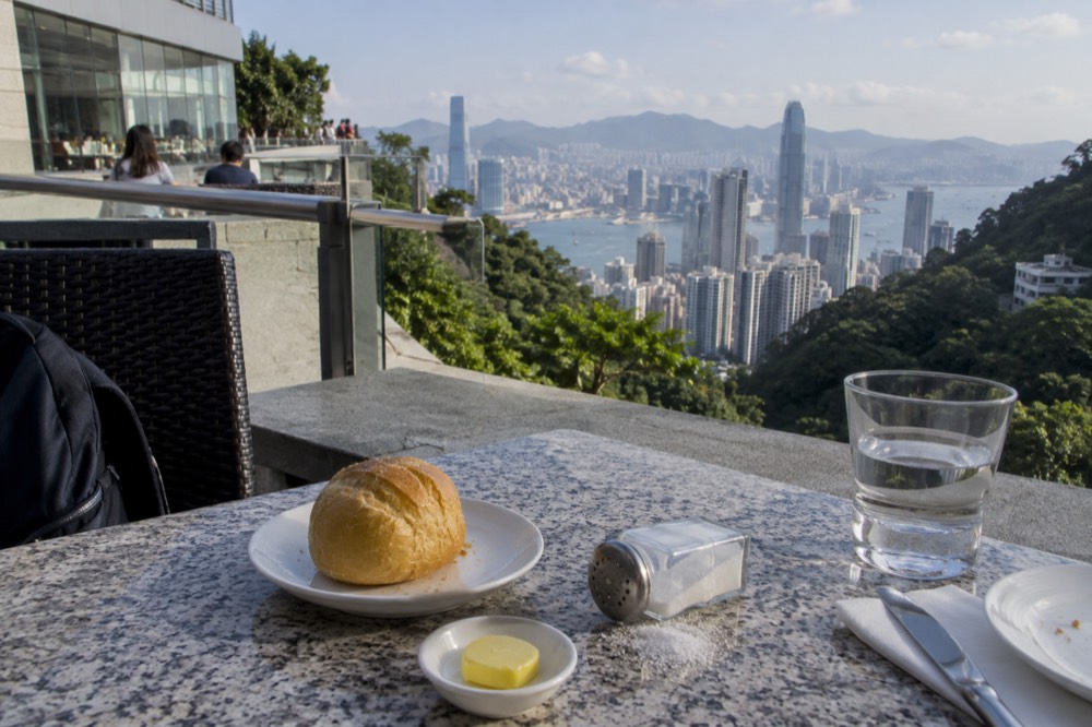 Table setting on a terrace with the harbour and skyline beyond